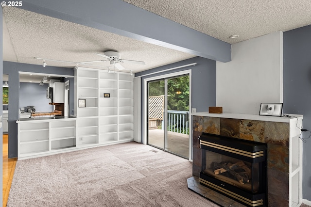 32505 Viewcrest Dr, Warren, OR 97053 - unfurnished living room featuring a textured ceiling, ceiling fan, and a tiled fireplace