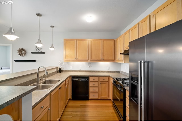 1108 S Holladay Dr Unit 24, Seaside, OR 97138 - kitchen with black appliances, light brown cabinets, light wood finished floors, decorative light fixtures, and under cabinet range hood