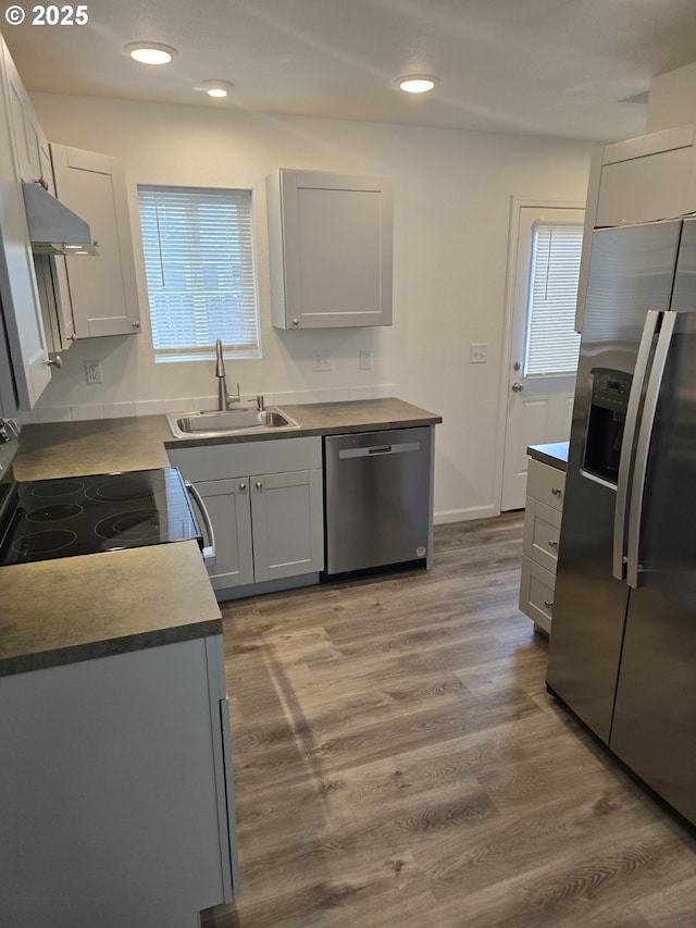3461 Concord St, Eugene, OR 97402 - kitchen with appliances with stainless steel finishes, under cabinet range hood, wood finished floors, and recessed lighting