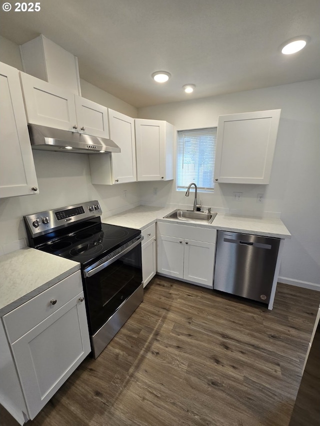 3461 Concord St, Eugene, OR 97402 - kitchen with stainless steel appliances, under cabinet range hood, white cabinets, dark wood-style floors, and recessed lighting