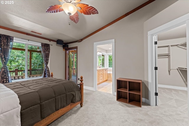 7444 SE 114th Ave, Portland, OR 97266 - bedroom with lofted ceiling, light colored carpet, a walk in closet, baseboards, and ensuite bath