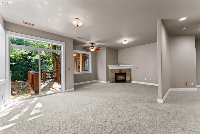 7444 SE 114th Ave, Portland, OR 97266 - unfurnished living room with carpet floors, baseboards, a ceiling fan, and a fireplace