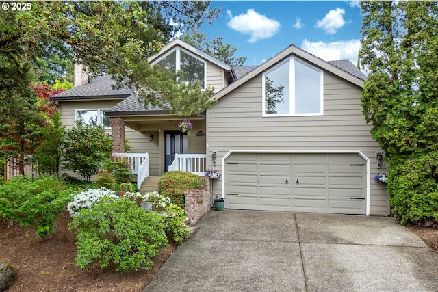 11255 SW Chickadee Ter, Beaverton, OR 97007 - view of front of home featuring an attached garage, driveway, a porch, roof with shingles, and a chimney