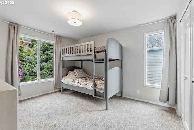 11255 SW Chickadee Ter, Beaverton, OR 97007 - bedroom featuring multiple windows, carpet flooring, and baseboards