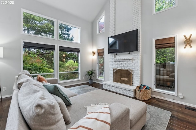 11255 SW Chickadee Ter, Beaverton, OR 97007 - living area featuring a high ceiling, baseboards, a fireplace, and wood finished floors