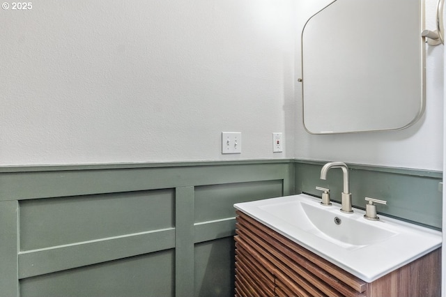 11255 SW Chickadee Ter, Beaverton, OR 97007 - bathroom featuring vanity, a decorative wall, and a wainscoted wall