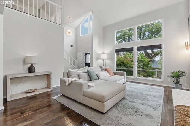 11255 SW Chickadee Ter, Beaverton, OR 97007 - living room with high vaulted ceiling, hardwood / wood-style flooring, stairs, and baseboards