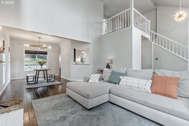 11255 SW Chickadee Ter, Beaverton, OR 97007 - living room with wood finished floors, a towering ceiling, baseboards, and stairway