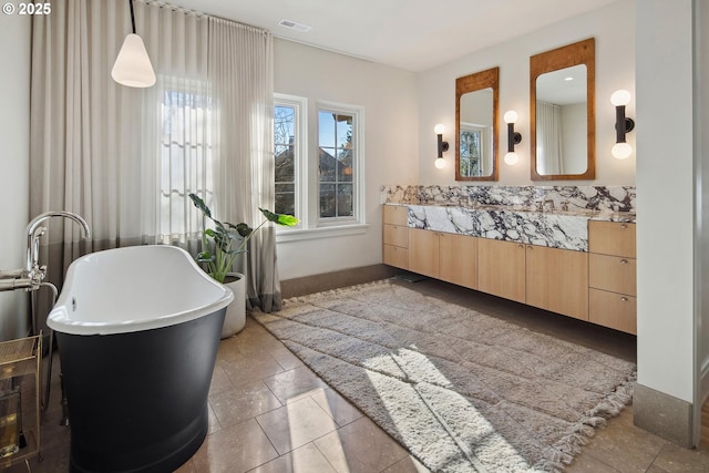 bathroom featuring vanity and a washtub