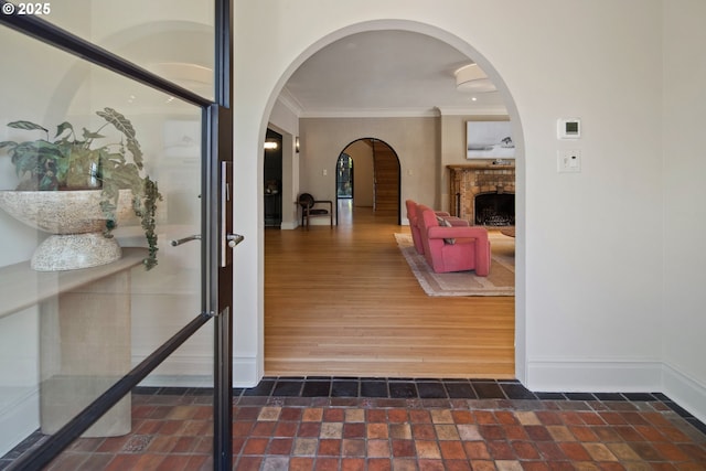 hall featuring ornamental molding and dark hardwood / wood-style floors