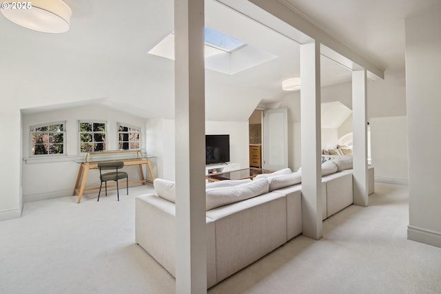 living room with light carpet and lofted ceiling with skylight