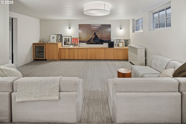 living room with light carpet and beverage cooler