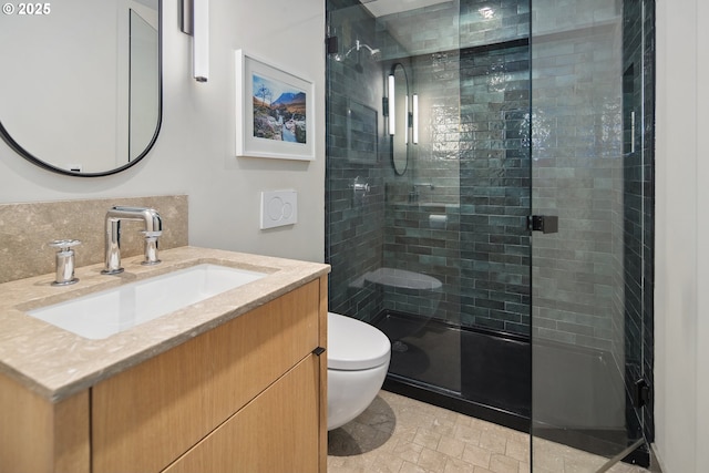 bathroom featuring decorative backsplash, vanity, toilet, and a shower with door