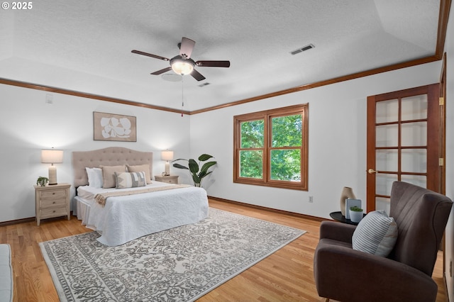 10670 NW La Cassel Crest Ln, Portland, OR 97229 - bedroom featuring crown molding, light wood-style floors, a textured ceiling, and ceiling fan