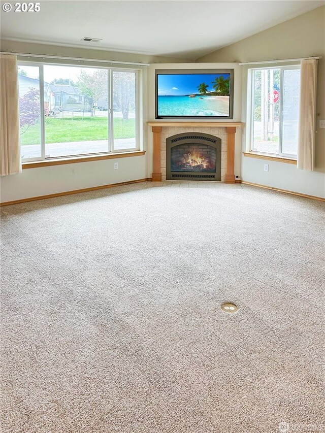 510 Oregon Ave N, Long Beach, WA 98631 - unfurnished living room featuring a tile fireplace, carpet floors, and lofted ceiling