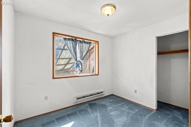 387 E Linden Way, Heppner, OR 97836 - unfurnished bedroom with a baseboard radiator, dark colored carpet, and a closet