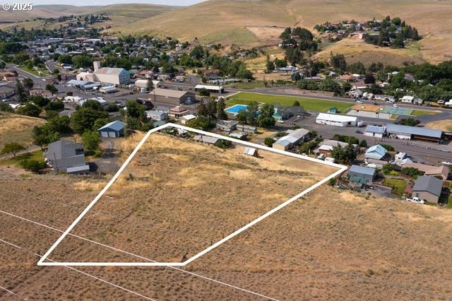 387 E Linden Way, Heppner, OR 97836 - aerial view of residential area with property boundaries highlighted and a mountain backdrop