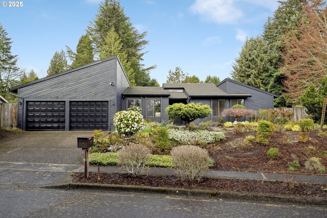 view of front of property with a garage and aphalt driveway