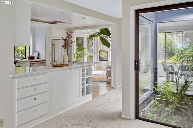 interior space with baseboards, light colored carpet, and recessed lighting