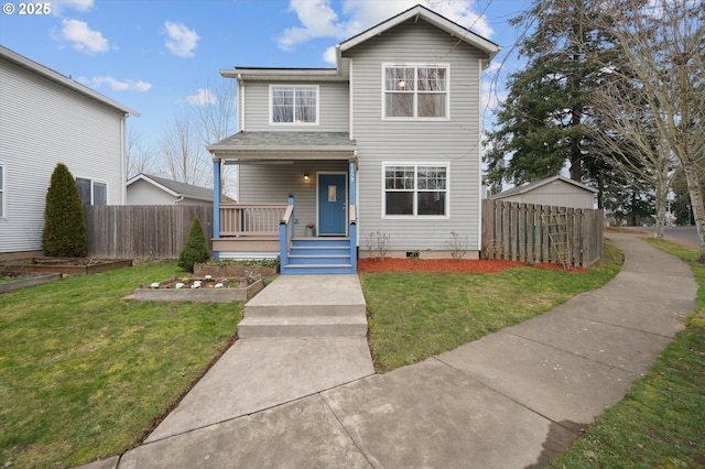 view of front of home with a front yard, covered porch, and a storage shed