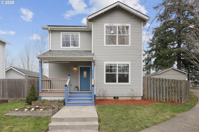 view of front of property featuring a front yard, covered porch, and a shed