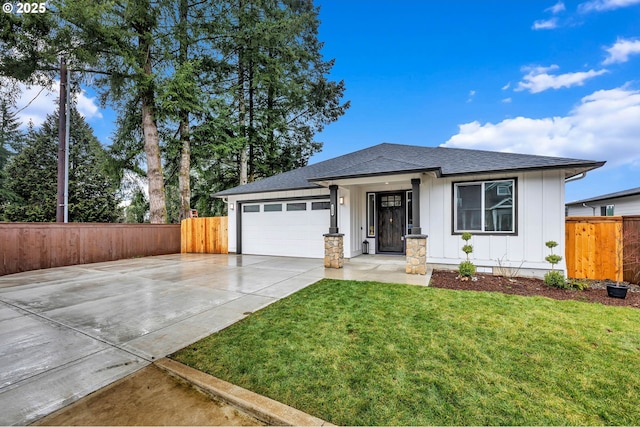 view of front of property featuring concrete driveway, an attached garage, board and batten siding, fence, and a front lawn