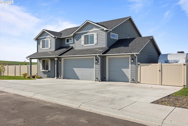 3 Patty Cir, Milton-Freewater, OR 97862 - view of front of property with concrete driveway, board and batten siding, a shingled roof, a garage, and a gate