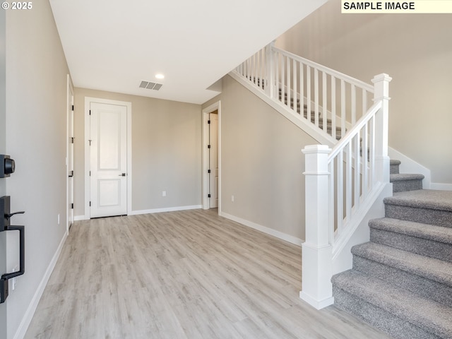 stairs featuring wood-type flooring