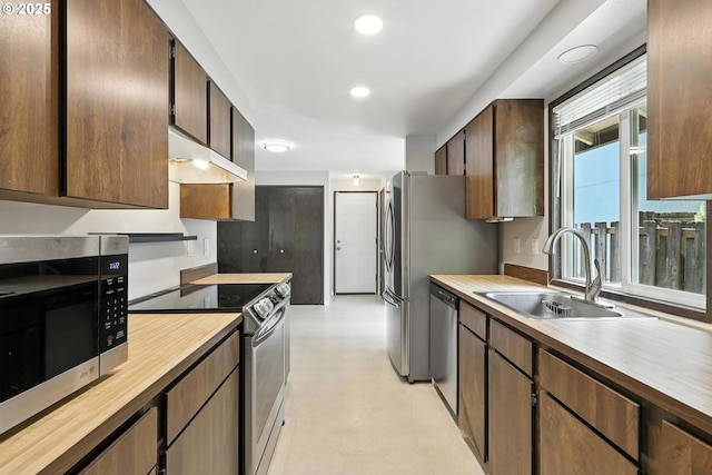 20603 SW Martinazzi Ave, Tualatin, OR 97062 - kitchen featuring stainless steel appliances, under cabinet range hood, recessed lighting, dark brown cabinets, and butcher block counters