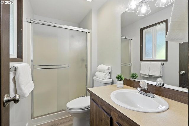 20603 SW Martinazzi Ave, Tualatin, OR 97062 - bathroom featuring vanity, a stall shower, and wood finished floors