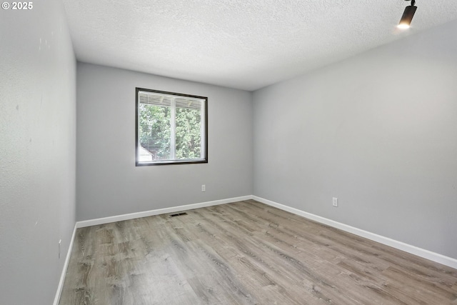 20603 SW Martinazzi Ave, Tualatin, OR 97062 - spare room featuring wood finished floors and a textured ceiling