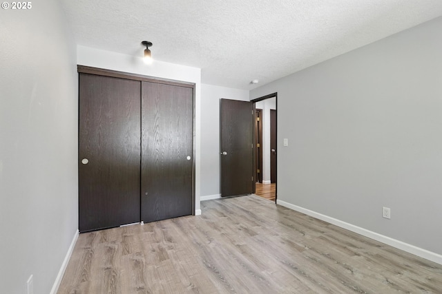 20603 SW Martinazzi Ave, Tualatin, OR 97062 - unfurnished bedroom featuring light wood finished floors, a textured ceiling, and a closet