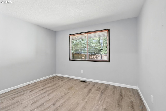 20603 SW Martinazzi Ave, Tualatin, OR 97062 - spare room with wood finished floors and a textured ceiling