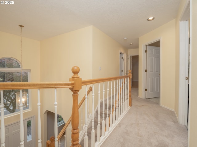 corridor with an upstairs landing, carpet flooring, recessed lighting, and baseboards