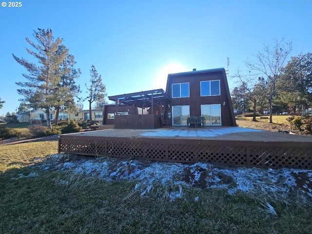 rear view of property with a wooden deck