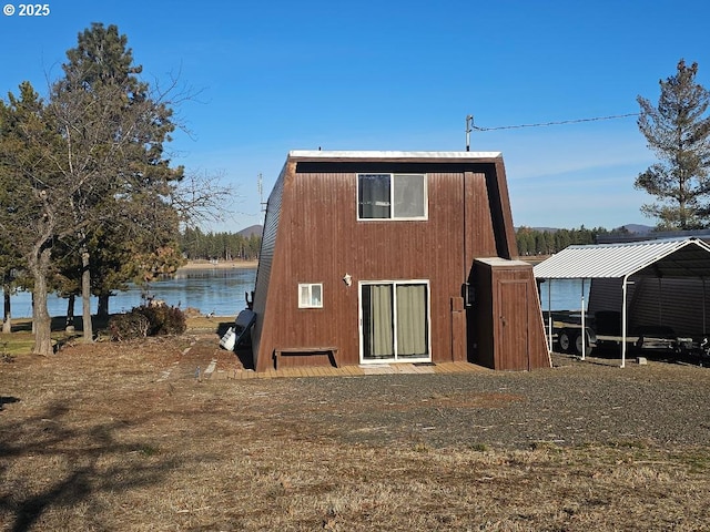 rear view of property with a water view