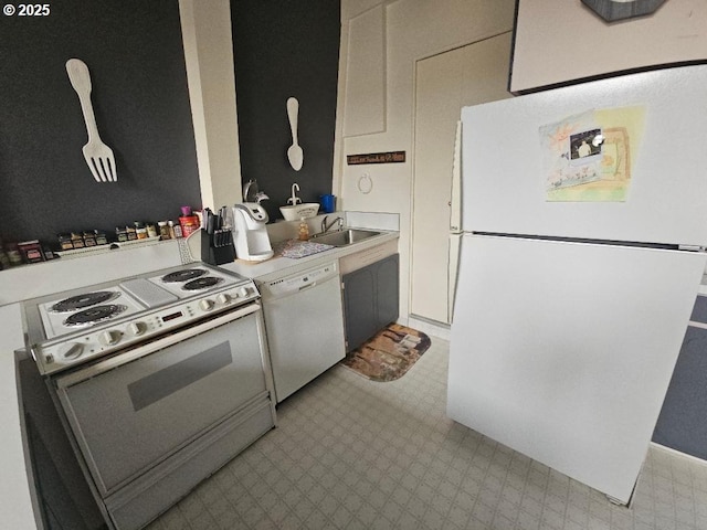 kitchen featuring white appliances and sink