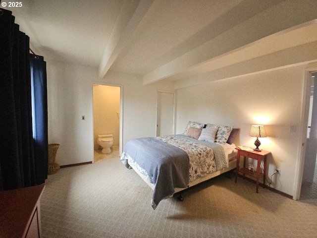 bedroom featuring ensuite bathroom, beam ceiling, and carpet