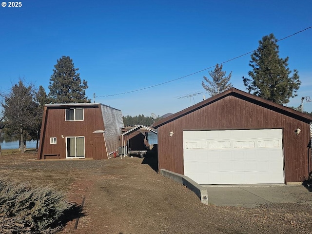 view of side of home featuring an outbuilding and a garage