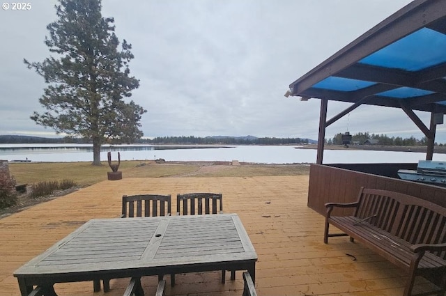 view of patio featuring a deck with water view