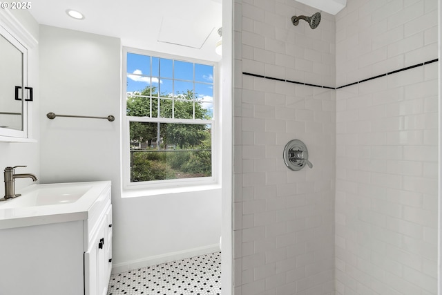 20 NW 16th Ave Unit 4, Portland, OR 97209 - bathroom featuring a tile shower, vanity, baseboards, and tile patterned floors