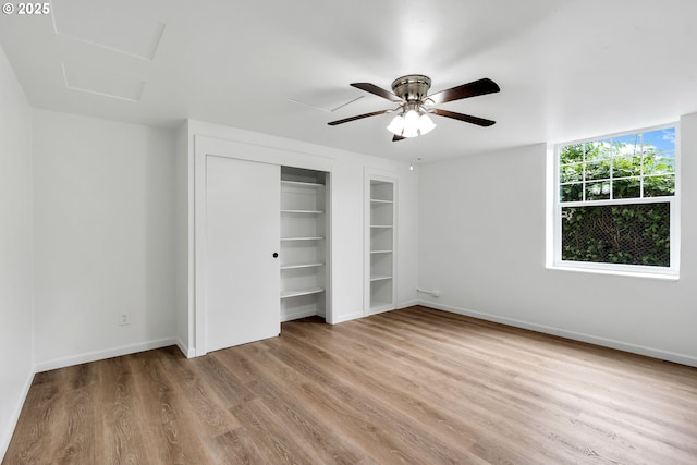 20 NW 16th Ave Unit 4, Portland, OR 97209 - unfurnished bedroom featuring wood finished floors, baseboards, a closet, and attic access
