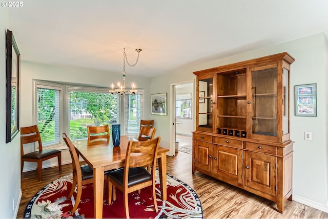 7605 SW Arbor Glen Ct, Wilsonville, OR 97070 - dining area with a chandelier and light wood finished floors