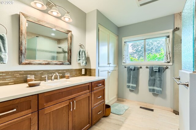 7605 SW Arbor Glen Ct, Wilsonville, OR 97070 - bathroom with vanity, decorative backsplash, and a shower