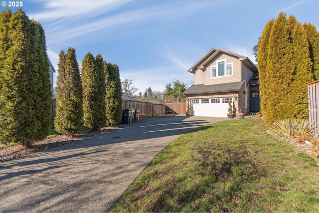 view of front of home with a garage and a front yard