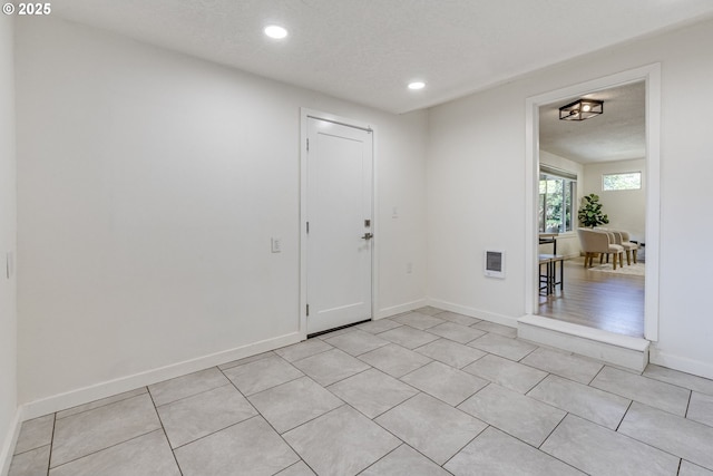 3711 N Alaska Pl, Portland, OR 97217 - foyer featuring recessed lighting, a textured ceiling, baseboards, and light tile patterned floors