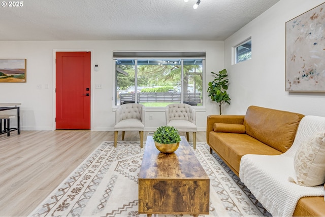 3711 N Alaska Pl, Portland, OR 97217 - living room with wood finished floors, healthy amount of natural light, a textured ceiling, and baseboards