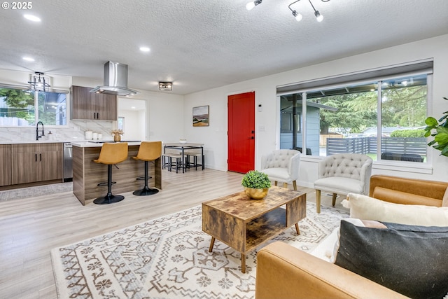 3711 N Alaska Pl, Portland, OR 97217 - living area with light wood-style flooring, a textured ceiling, and recessed lighting