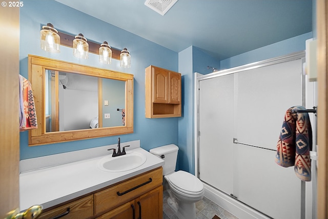 bathroom featuring vanity, toilet, and an enclosed shower