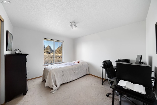 bedroom with light carpet and a textured ceiling